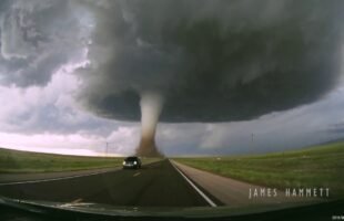 Storm chasing dashcam: Tornado crossing the highway! Laramie, Wyoming